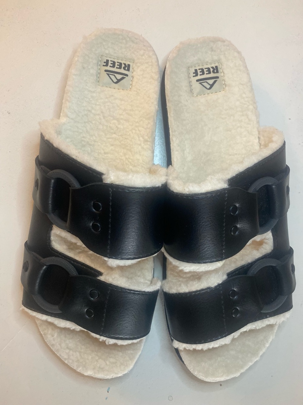 Reef Black Slide Sandals with Cream Sherpa Lining